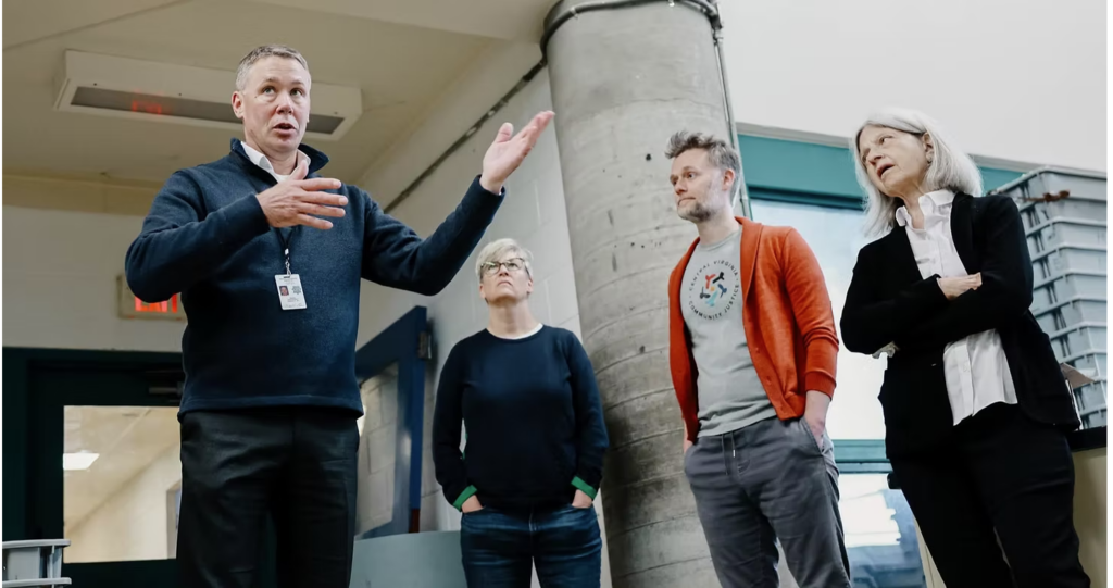 4 people standing in the lobby of the jail, including Col. Martin Kumer